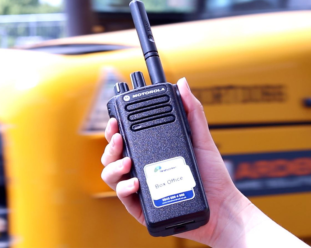 a hand holding a tow way radio at and event